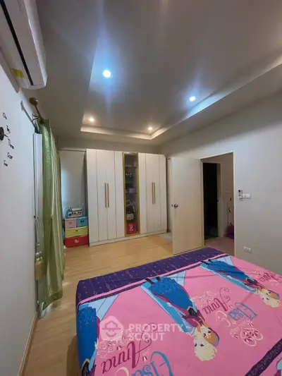 Spacious bedroom with modern lighting and ample storage