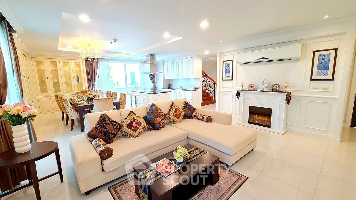 Luxurious open-plan living room with elegant decor and modern kitchen in a spacious apartment.