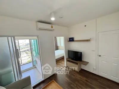 Modern apartment interior with balcony and bedroom view, featuring sleek design and natural light.