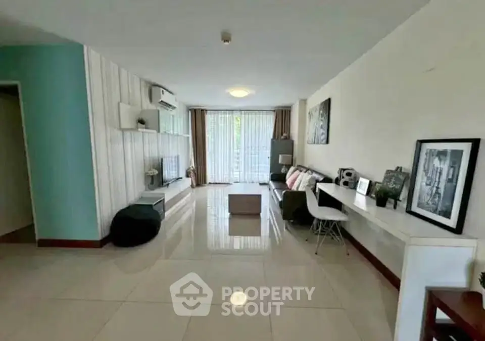 Spacious living room with modern decor and large windows for natural light