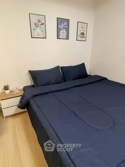 Cozy bedroom with modern decor and stylish bedding in a real estate property.