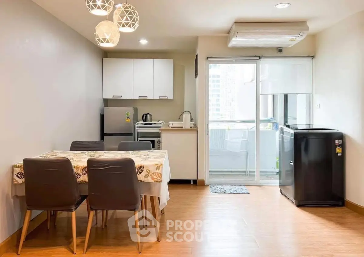 Modern dining area with kitchen and balcony access in a stylish apartment.