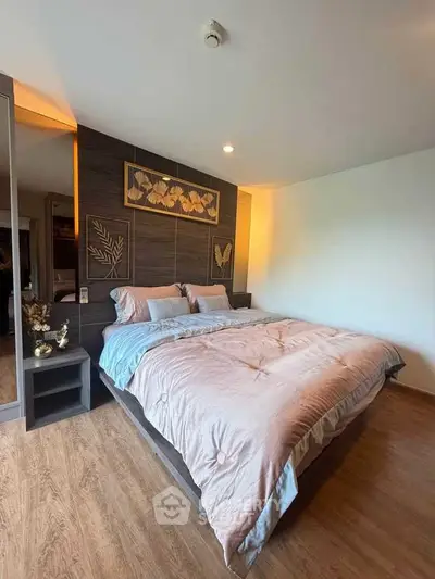 Luxurious bedroom with elegant decor and cozy bedding in modern apartment.