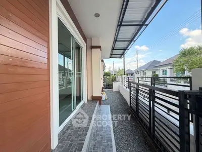Modern house exterior with sleek design and spacious balcony area.