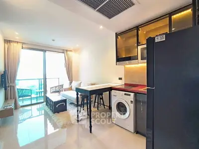 Modern open-plan living room with kitchen and balcony view