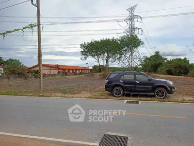 Spacious land plot with potential for development, featuring nearby utilities and road access.