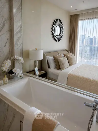 Luxurious bedroom with ensuite bathtub and city view, featuring elegant decor and natural light.