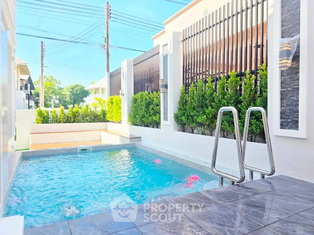 Luxurious private pool with modern design and lush greenery, perfect for relaxation and entertainment.