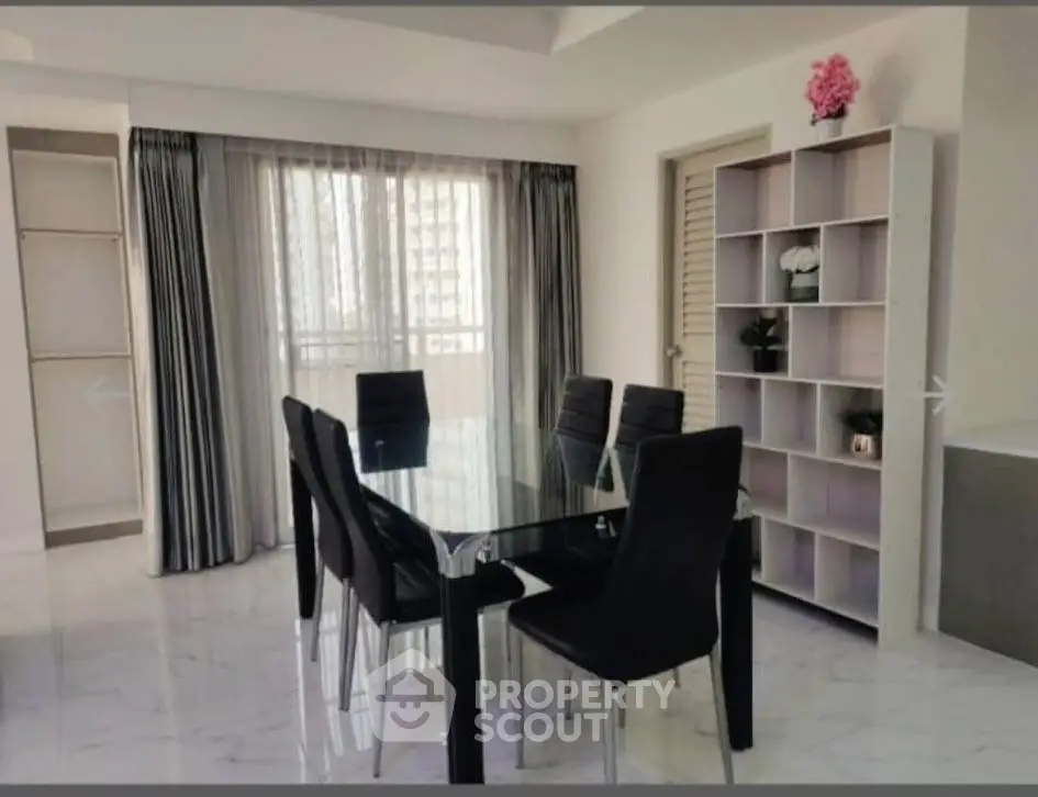 Elegant dining area with glass table and modern chairs in a bright apartment