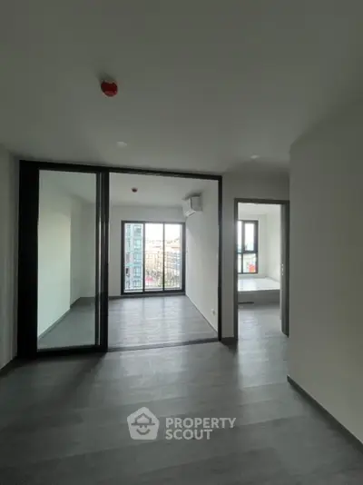 Modern apartment interior with large windows and sleek flooring