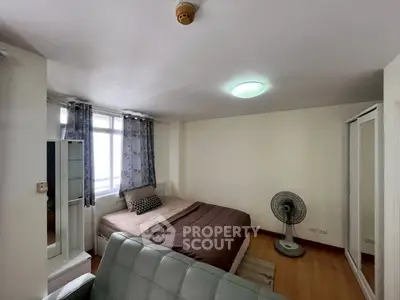 Cozy bedroom with modern decor and ample natural light, featuring a comfortable bed and stylish furnishings.