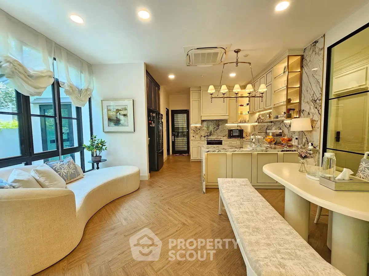 Luxurious open-layout kitchen and living area with elegant decor and modern appliances.