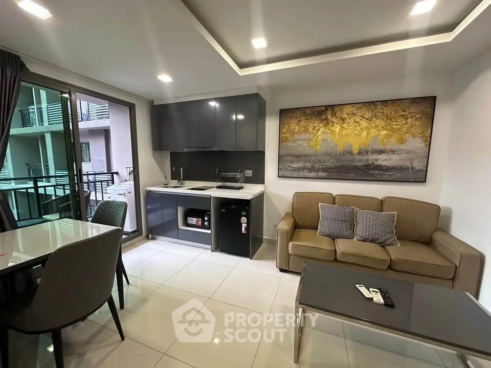 Modern living room with sleek kitchen and balcony access in stylish apartment