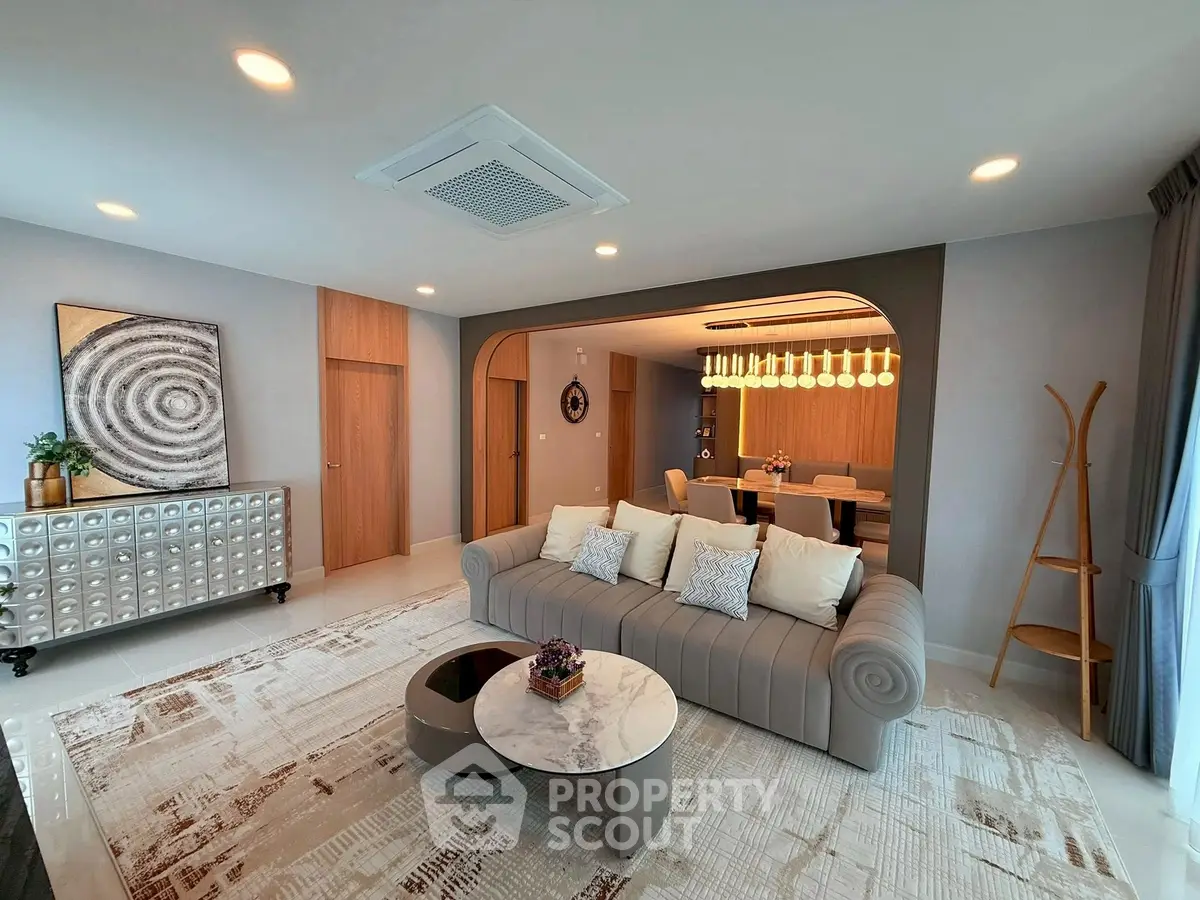 Luxurious living room with modern decor and elegant dining area