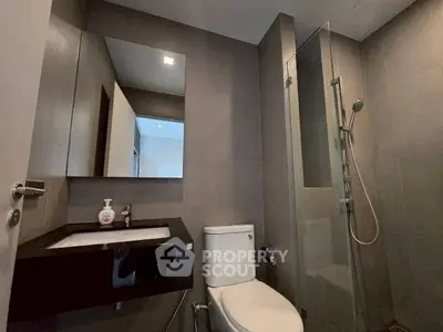 Modern bathroom with sleek fixtures and glass shower enclosure