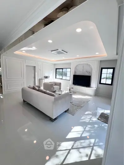 Luxurious modern living room with elegant decor and ample natural light.