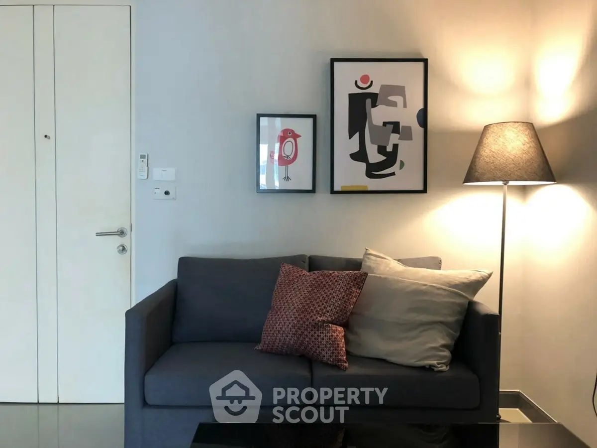 Stylish living room with modern art and cozy sofa in contemporary apartment.
