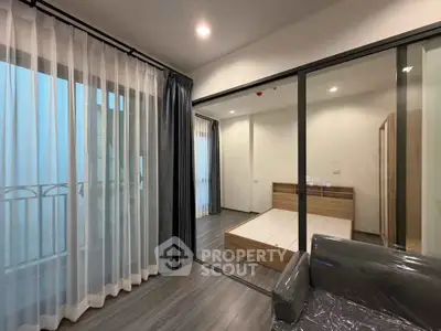 Modern apartment interior with glass partition and balcony view