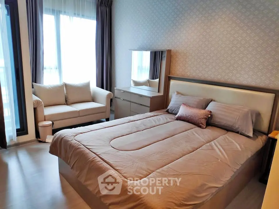 Cozy bedroom with elegant decor and natural light, featuring a plush bed and stylish furniture.