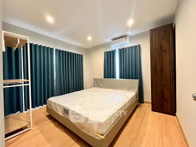 Spacious bedroom with modern furnishings and natural light