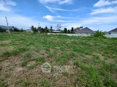 Spacious vacant land with lush greenery and clear blue skies, perfect for building your dream home.