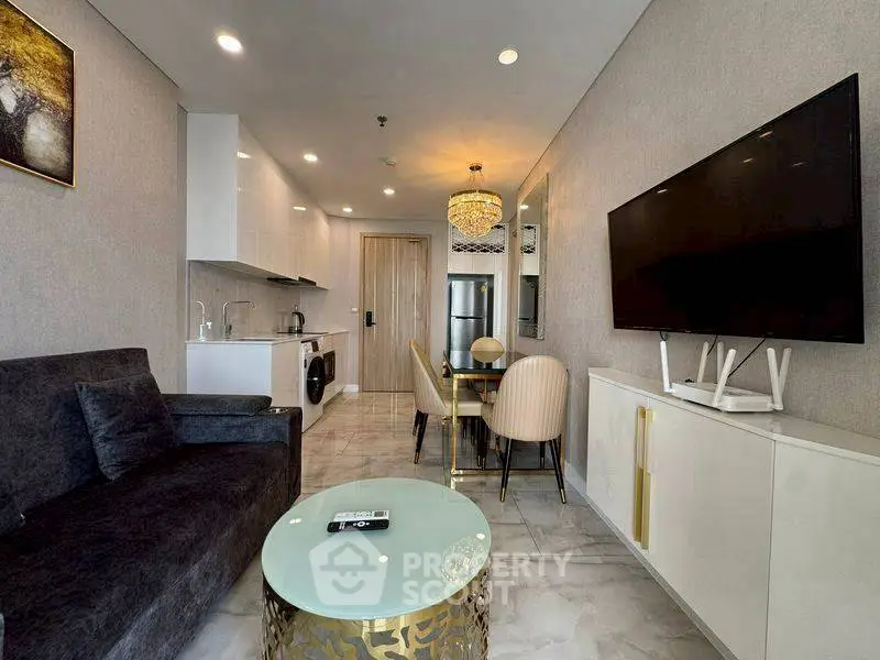 Modern living room with open kitchen, elegant decor, and stylish furniture