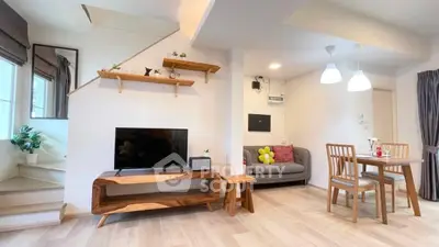 Modern living room with stylish wooden furniture and open dining area, perfect for cozy gatherings.
