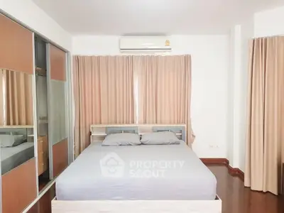 Spacious bedroom with modern design and ample natural light