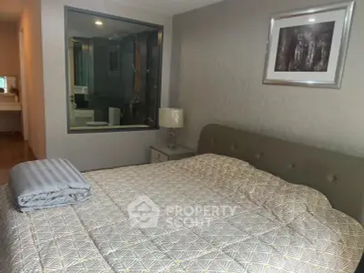 Modern bedroom with stylish decor and ensuite bathroom view