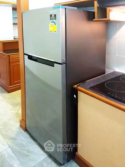 Modern kitchen with sleek stainless steel refrigerator and induction cooktop