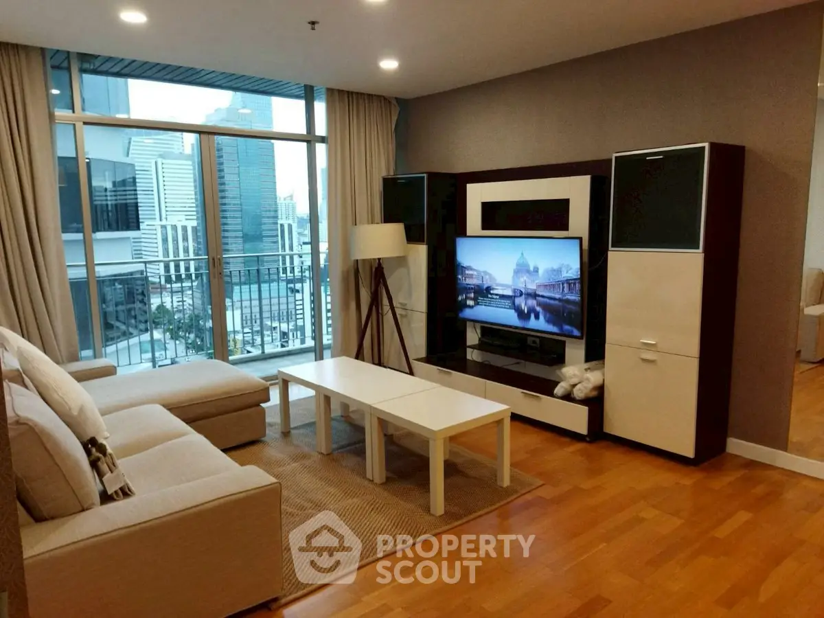 Modern living room with city view, stylish furniture, and large windows.
