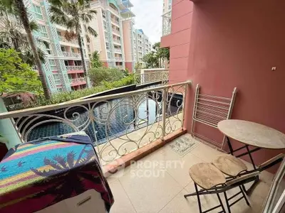 Charming balcony with pool view in modern apartment complex