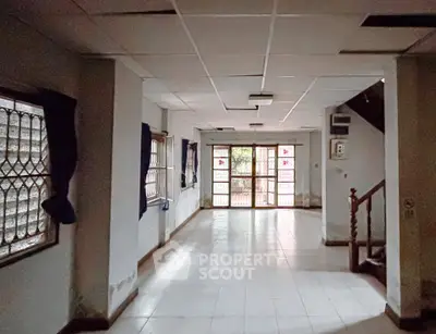 Spacious open-plan living area with large windows and natural light