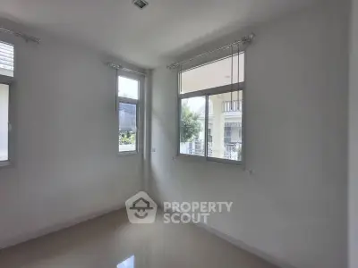 Bright empty room with large windows and glossy floor, ideal for customization.