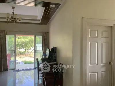 Spacious living room with elegant ceiling design and garden view