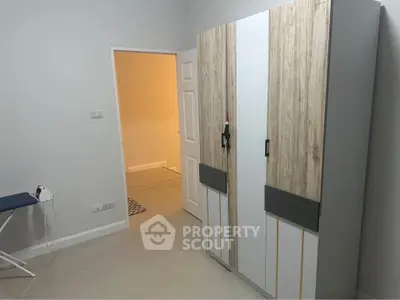 Modern bedroom with sleek wardrobe and minimalistic design