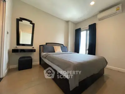 Modern bedroom with stylish decor and natural light, featuring a comfortable bed and elegant furnishings.