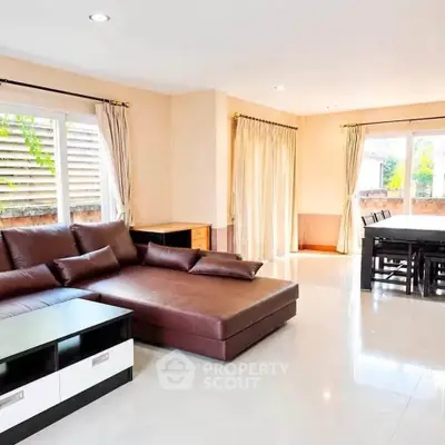 Spacious living room with modern furniture and large windows for natural light