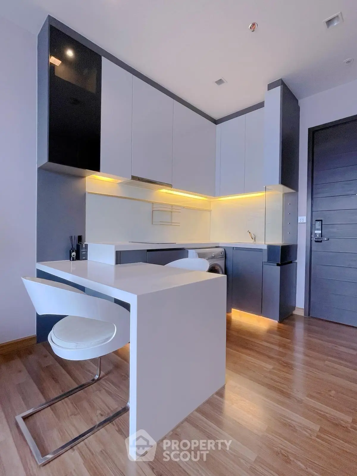 Modern kitchen with sleek cabinetry and integrated appliances in a stylish apartment.