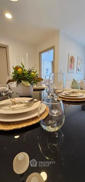 Elegant dining setup in modern living room with stylish decor and natural light.