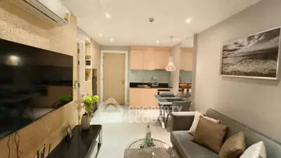 Modern living room with sleek design and cozy ambiance, featuring a stylish kitchen and comfortable seating area.