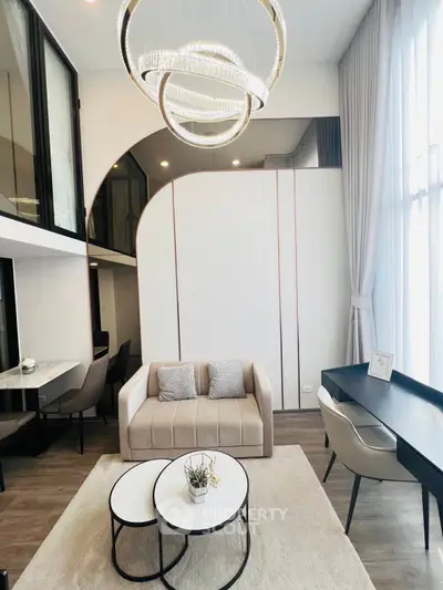 Modern living room with elegant chandelier and stylish furniture