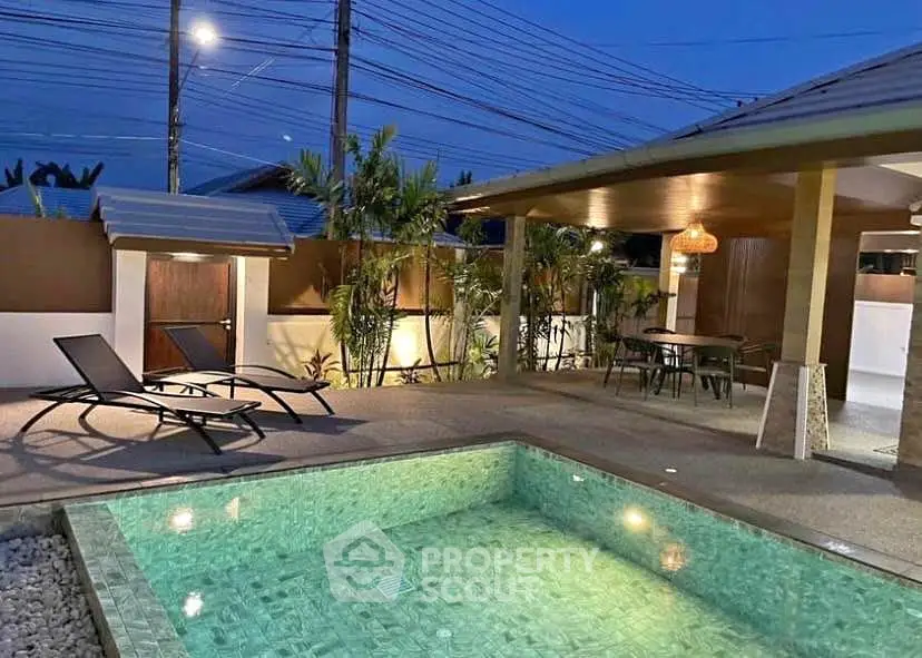 Luxurious outdoor pool area with modern lounge chairs and ambient lighting
