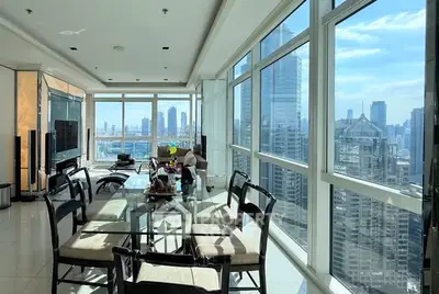 Luxurious corner unit with panoramic city views and spacious dining area.