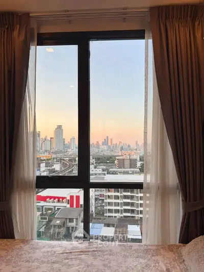 Stunning cityscape view from a cozy bedroom window, perfect urban living experience.