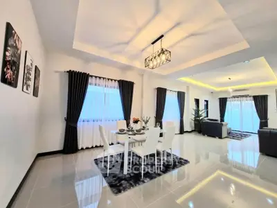 Spacious modern living and dining area with elegant decor and natural light.