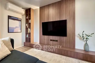 Modern living room with sleek wooden paneling and wall-mounted TV