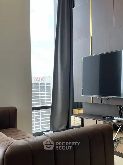 Modern living room with sleek TV setup and city view through large window.