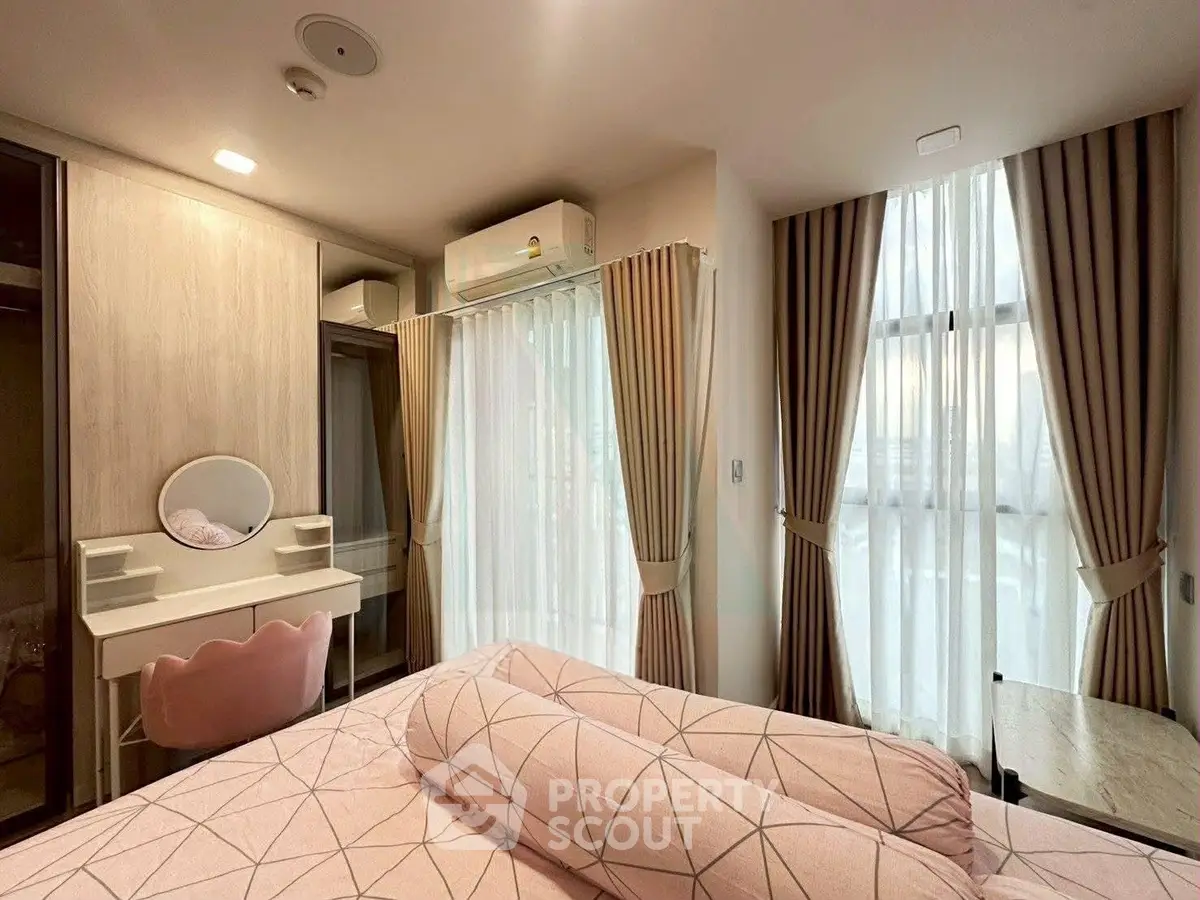 Chic bedroom with stylish decor, ample natural light, and elegant furnishings for a cozy living experience.