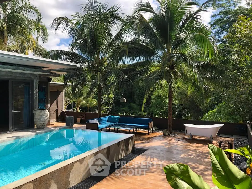 Luxurious tropical villa with private pool and lush palm trees, perfect for serene relaxation.